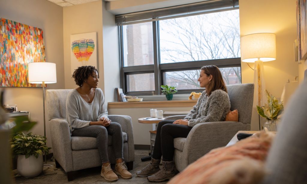 Individual therapy session integrated with medication-assisted treatment showing compassionate counselor supporting client in Massachusetts recovery program