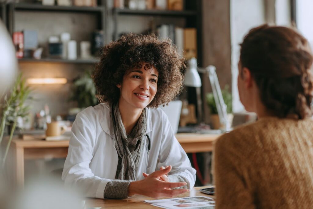 Compassionate medical provider consulting with patient about medication-assisted treatment options for opioid use disorder in Massachusetts treatment center